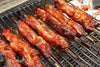 country style ribs on skewers cooking on a grill