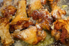 chicken wings coated in shredded parmesan cheese and minced garlic