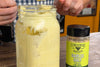 jar of homemade mayonnaise with a bottle of Garlic Salt seasoning