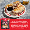 French Dip sandwich with fries and a drink on a plate, featuring Big Dipper Au Jus mix packaging.