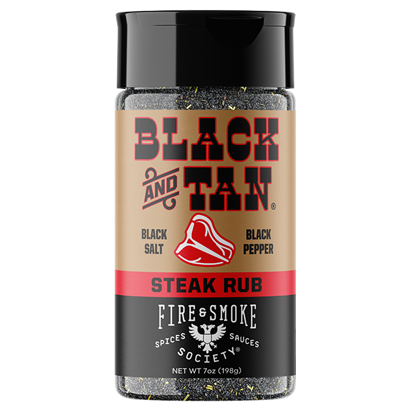 A bottle of Fire & Smoke Spices Sauces Society Black and Tan Steak Rub, featuring a black cap, a tan and black label with a red stripe and steak graphic, and visible black pepper flakes inside a clear container.