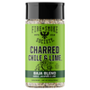 A bottle of Fire & Smoke Society Charred Chile & Lime seasoning, featuring a bright green label and a black cap, set against a plain white background.