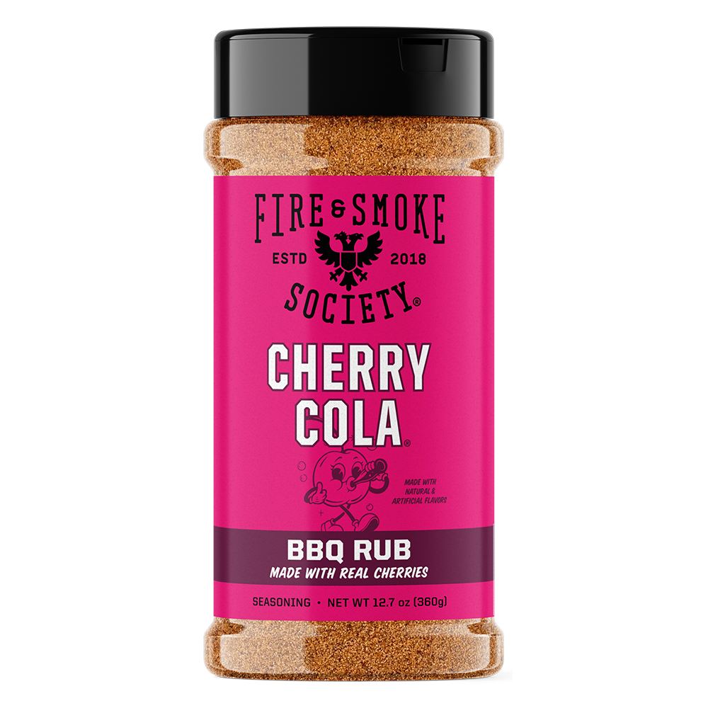 A bottle of Fire & Smoke Society Cherry Cola BBQ Rub seasoning, featuring a bright pink label with a black cap, set against a plain white background.