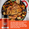A bottle of Fire & Smoke Society Delicious Mix all-purpose seasoning blend is shown in front of a roasted whole chicken with potatoes, carrots, and garlic in a red cast-iron skillet. White text on an orange banner at the bottom describes the seasoning blend ingredients and uses.