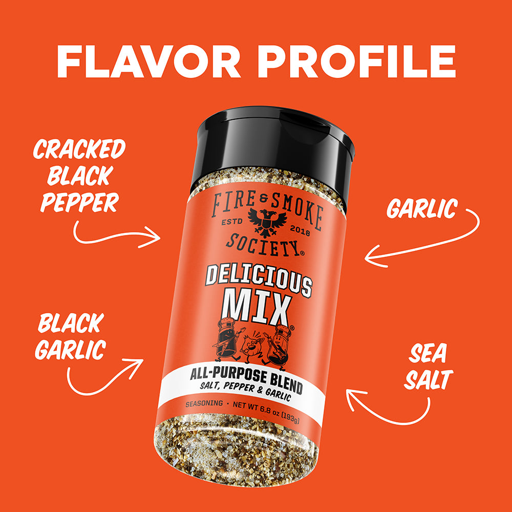 A seasoning bottle labeled Fire & Smoke Society Delicious Mix All-Purpose Blend, shown on a bright orange background with white text and arrows pointing to flavor components: cracked black pepper, garlic, black garlic, and sea salt.
