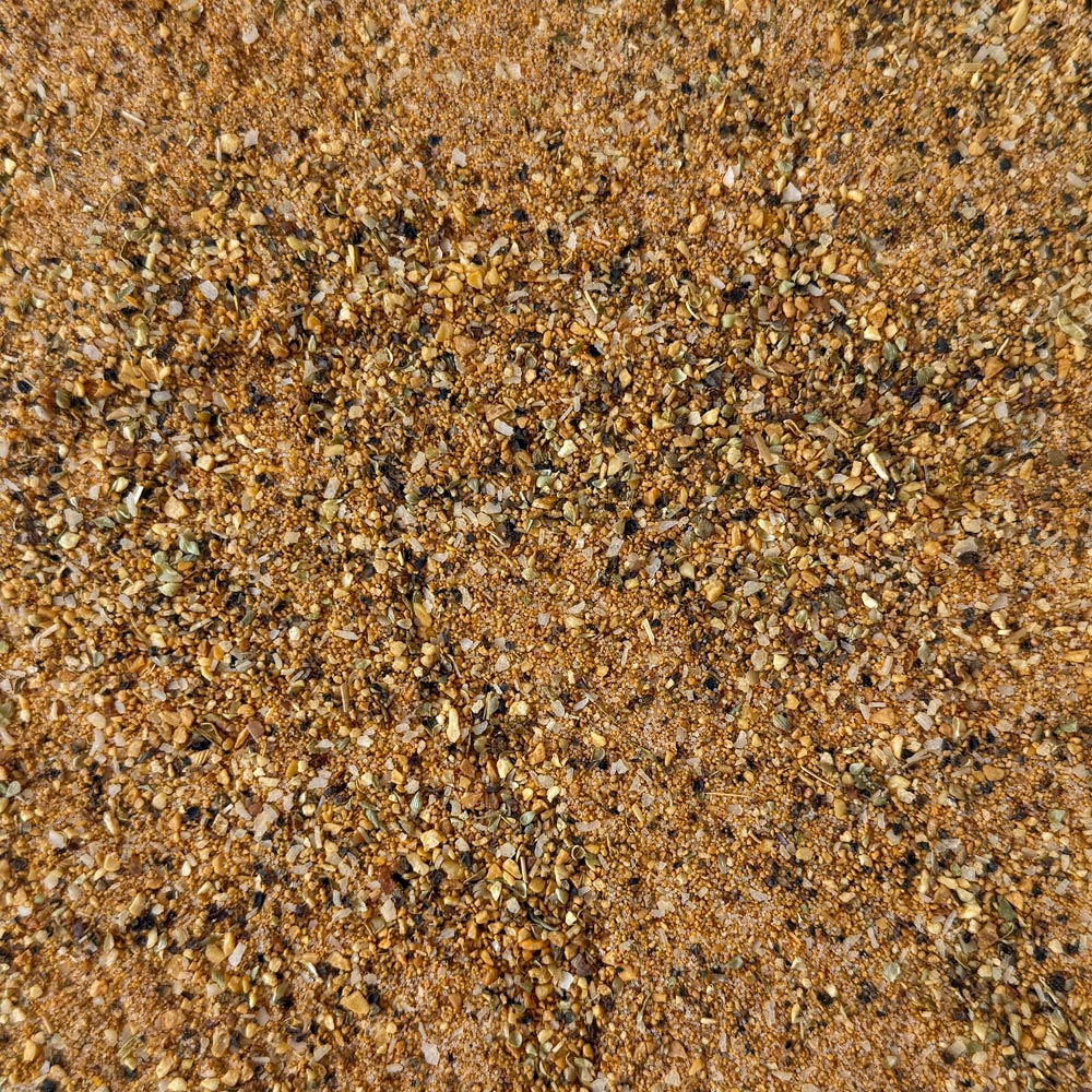 A close-up texture shot of Holy Garlic seasoning