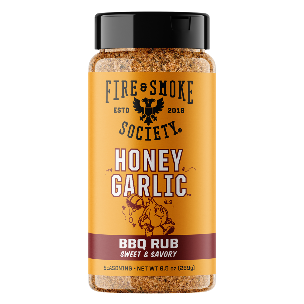 A bottle of Fire & Smoke Society Honey Garlic BBQ Rub Sweet & Savory seasoning, featuring a bright yellow label with a black cap and brown seasoning visible inside, set against a plain white background.