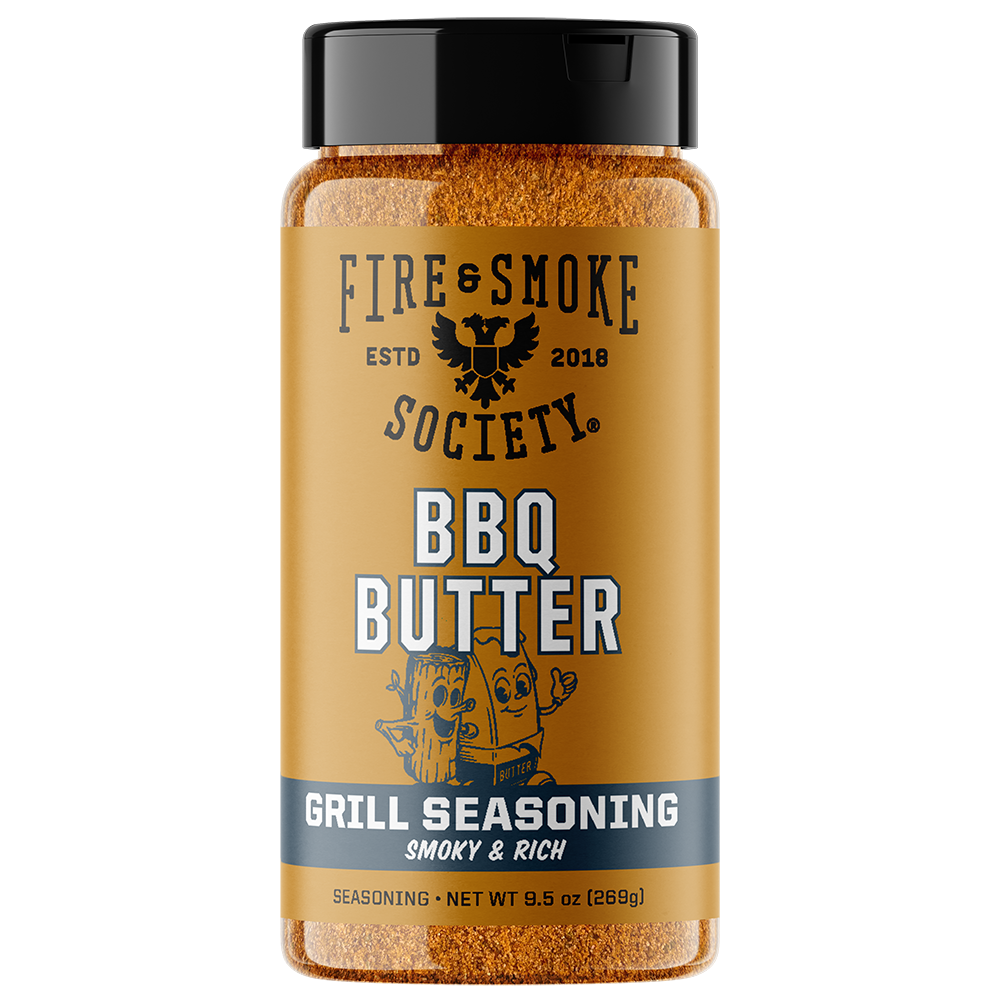 A bottle of Fire & Smoke Society BBQ Butter Grill Seasoning, featuring a golden-brown label, black cap, and visible orange-brown seasoning inside, set against a plain white background.