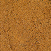 A close-up texture shot of BBQ seasoning with a warm golden-brown color and small dark specks.