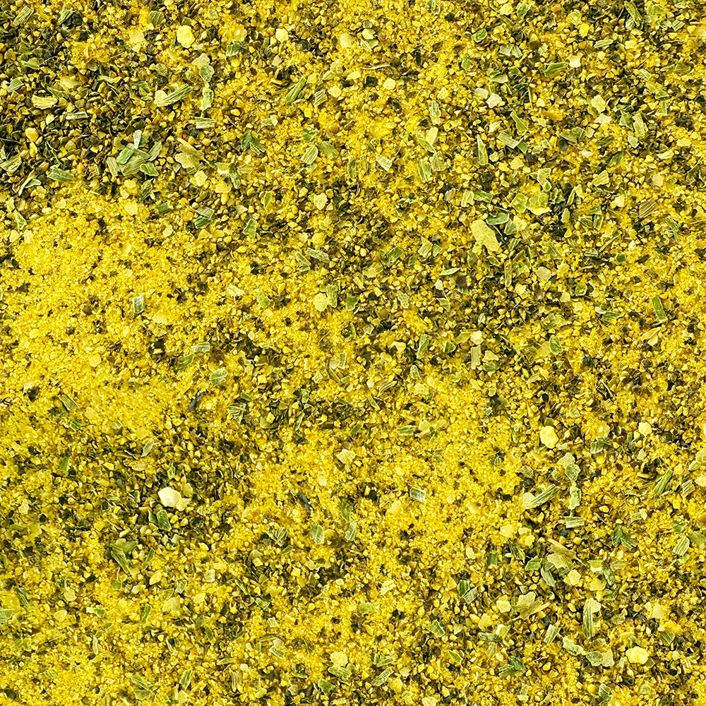 A bottle of Fire & Smoke Society Lemon Pepper seasoning with a bright yellow label, black cap, and visible golden peppercorns inside, on a plain white background.
