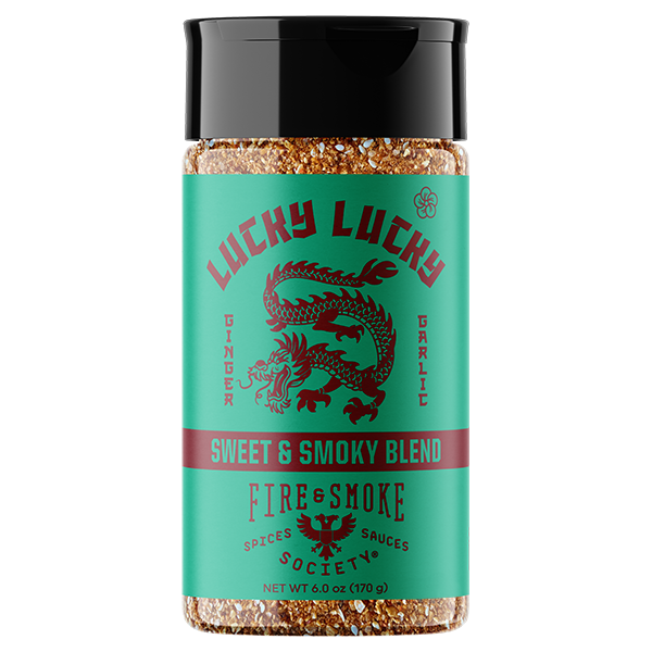 A bottle of Lucky Lucky Spice Shop Fire & Smoke Sweet & Smoky Blend seasoning. The product features a bright teal-green label with a red dragon illustration and a black cap