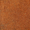A close-up texture shot of a fine, granular reddish-brown spice blend