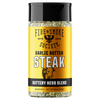 A bottle of Fire & Smoke Society Garlic Butter Steak Buttery Herb Blend seasoning, featuring a bright yellow label with black and white text, a cow illustration, and a black cap