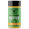 A bottle of Fire & Smoke Society Honey Jalapeño Butter Grill Blend seasoning, featuring a green label with a black cap and orange accent band, on a white background.
