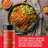 A bottle of Noodle House Asian Noodle Blend seasoning is shown in the foreground, with a plated prepared noodle dish featuring sliced meat, lime, cucumber, and sesame seeds in the background. A red text banner appears at the bottom with product claims.