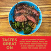 Blue plate with sliced steak, broccoli, and onions on a wooden surface with promotional text.
