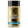 A bottle of Fire & Smoke Society Steak Perfect Garlic & Sea Salt seasoning, featuring a gold label with a black cap and a blue accent band, set against a plain white background.