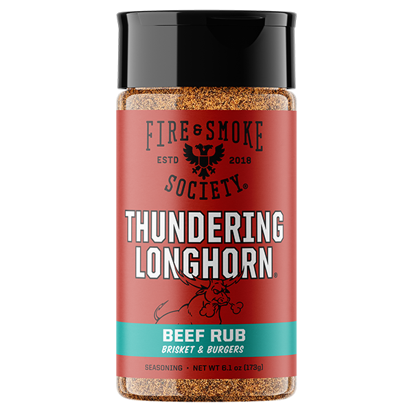 A bottle of Fire & Smoke Society Thundering Longhorn Beef Rub seasoning, featuring a red label with a black cap and a turquoise accent band at the bottom, set against a plain white background.