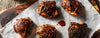 chicken thighs covered in barbecue sauce