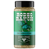A bottle of Rodeo Ranch Fire & Smoke Society Chicken & Fish seasoning, featuring a green label with a black cap and a graphic of a cowboy riding a rooster.