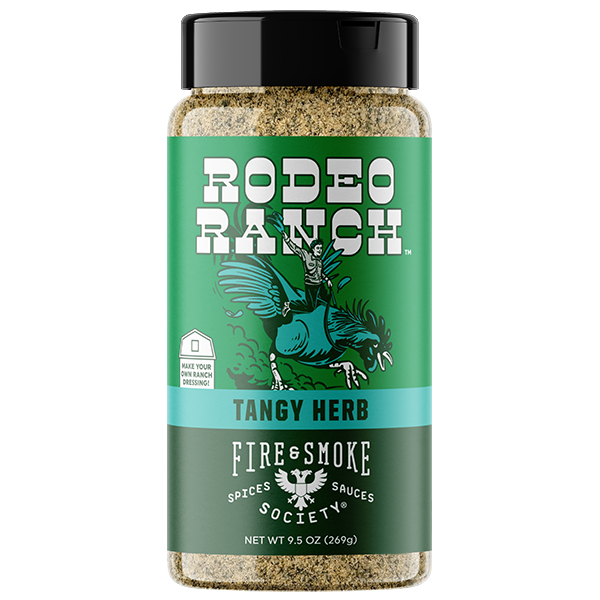 A bottle of Rodeo Ranch Fire & Smoke Spices & Sauces 'Tangy Herb' seasoning, featuring a green label with a black cap