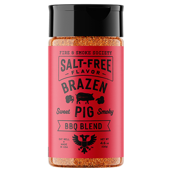A bottle of Fire & Smoke Society Brazen Sweet Pig Smoky BBQ Blend seasoning, featuring a bright red label and a black cap