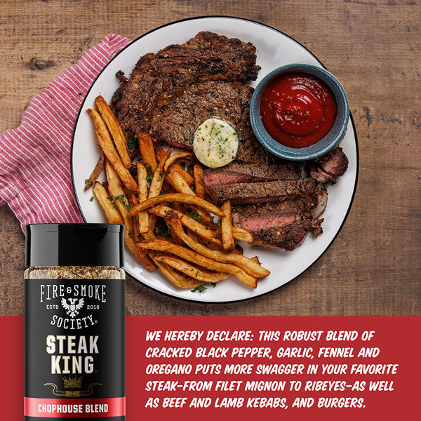 Steak, fries, and ketchup on a plate with Steak King seasoning bottle.