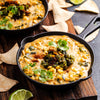 Iron skillet filled with street corn dip