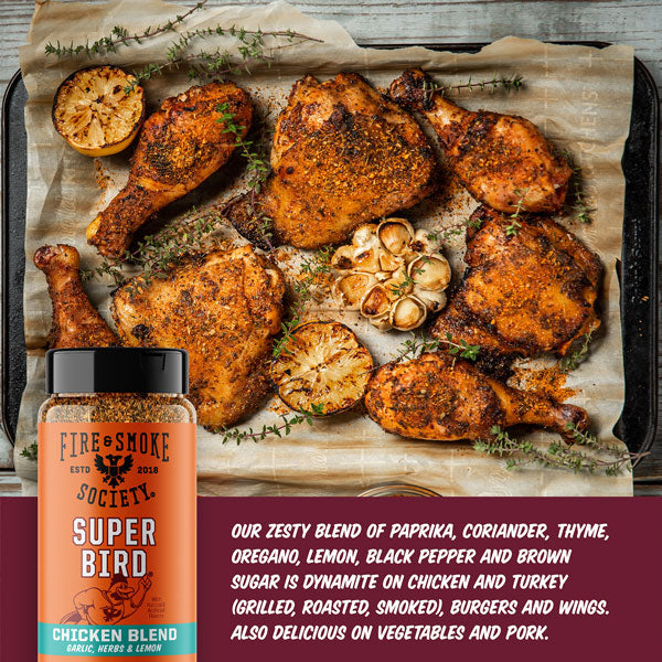 Roasted chicken pieces on a baking tray with a bottle of 'Super Bird' seasoning blend.