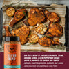 Roasted chicken pieces on a baking tray with a bottle of 'Super Bird' seasoning blend.