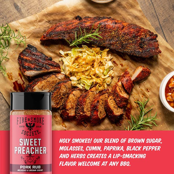 Grilled pork ribs with coleslaw on brown paper, accompanied by a bottle of 'Sweet Preacher' pork rub.