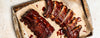 bbq ribs on a baking tray with parchment paper