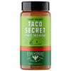 A bottle of Tommy Taylor's Taco Secret Street Taco Blend seasoning by Fire & Smoke Society, featuring a green and dark green label with a black cap, on a white background.