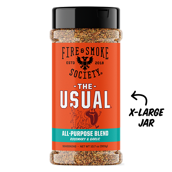 A bottle of Fire & Smoke Society 'The Usual' All-Purpose Blend seasoning, shown as an X-large jar with a black lid and a bright orange label, on a white background