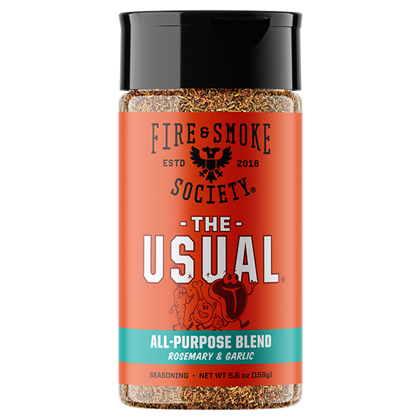 A bottle of Fire & Smoke Society 'The Usual' All-Purpose Blend seasoning, featuring a bright orange label with a black cap and visible brown seasoning inside, set against a plain white background.