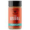 A bottle of Fire & Smoke Society 'The Usual' All-Purpose Blend seasoning, featuring a bright orange label with a black cap and visible brown seasoning inside, set against a plain white background.