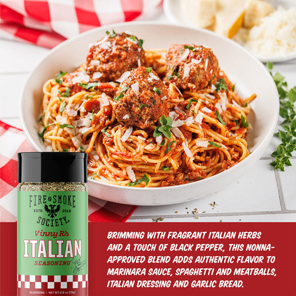 Spaghetti with meatballs and a bottle of Italian seasoning on a checkered tablecloth.